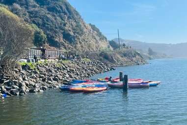 Kayaks in the water near a rocky coastline in Northern California